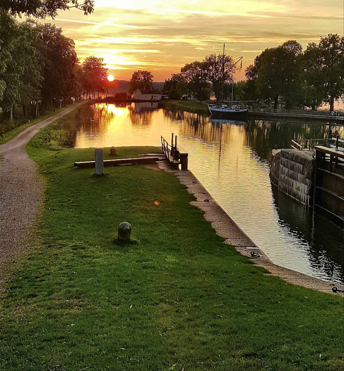 Sunset over Göta Canal in Sjötorp. Here a Local guide can take you with the bike to see the locks and take you to the island Torsö with the koncept Meet the Locals
